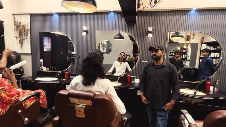 Barber at work with a customer at Deep Cuts